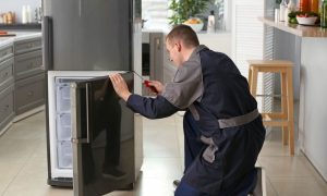 Man repairing freezer