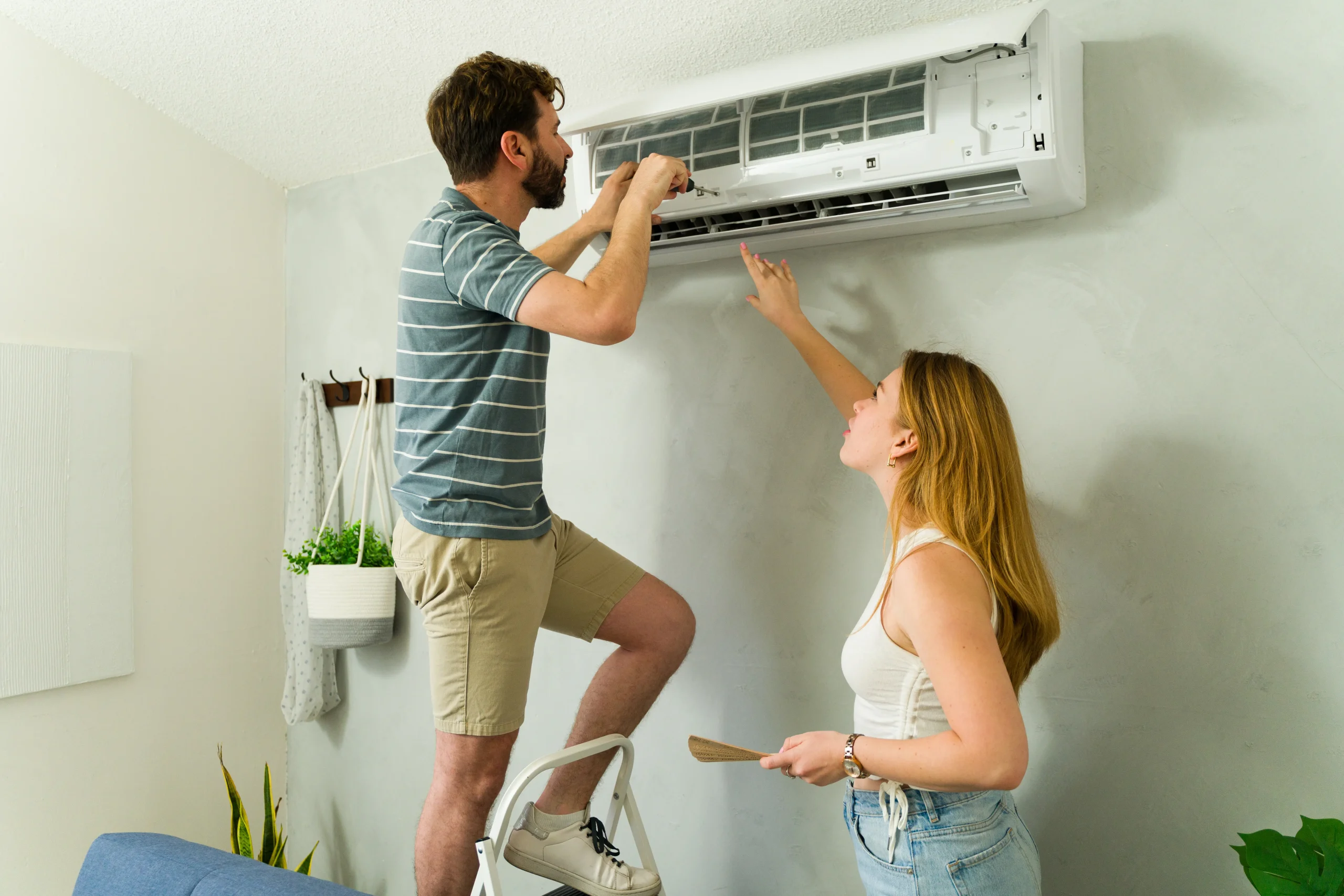 Technician repairing a residential air conditioning unit